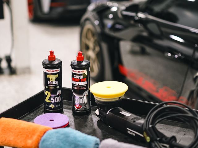 Detailing products and a polisher laid out ready