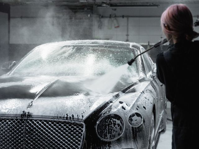 A car under thick snow foam